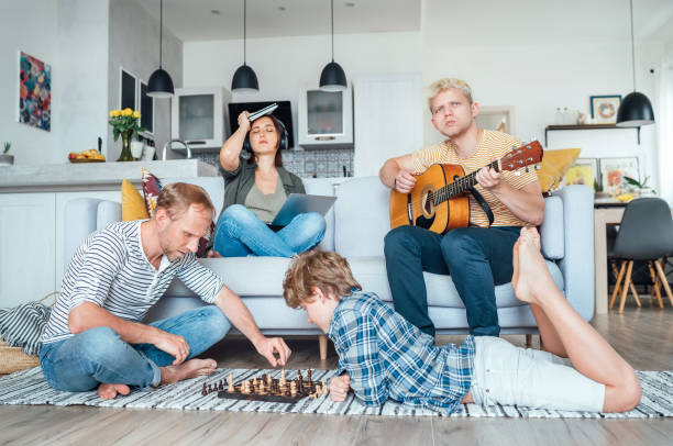 family all together in a living room practicing various hobbies