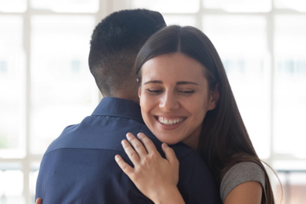 man and woman hugging