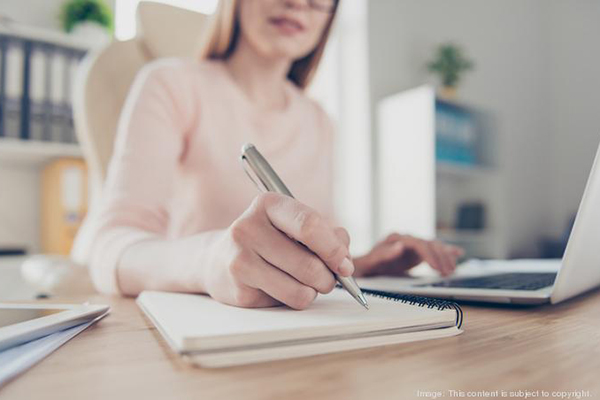 woman writing in notebook